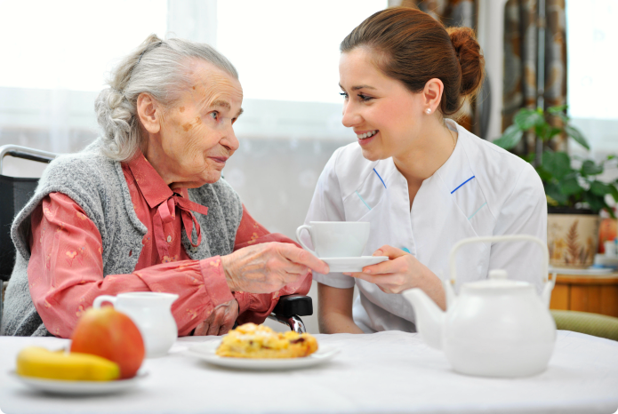 caregiver helping her patient in eating